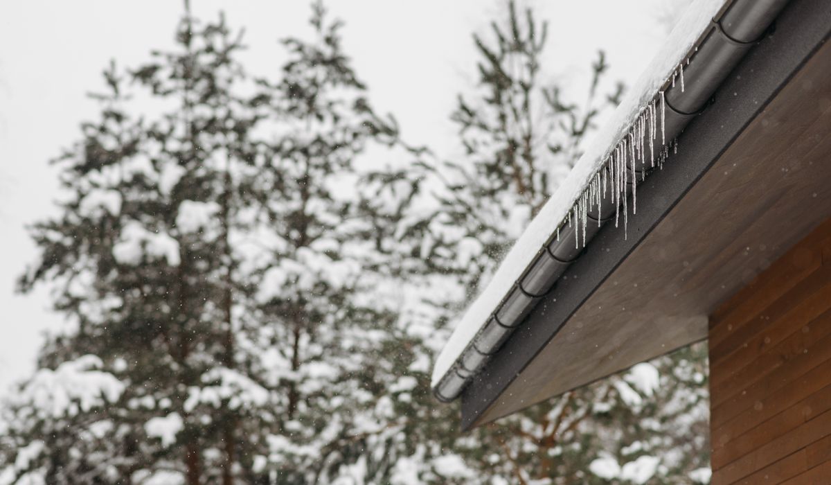 Icicles hanging from a snow-covered roof