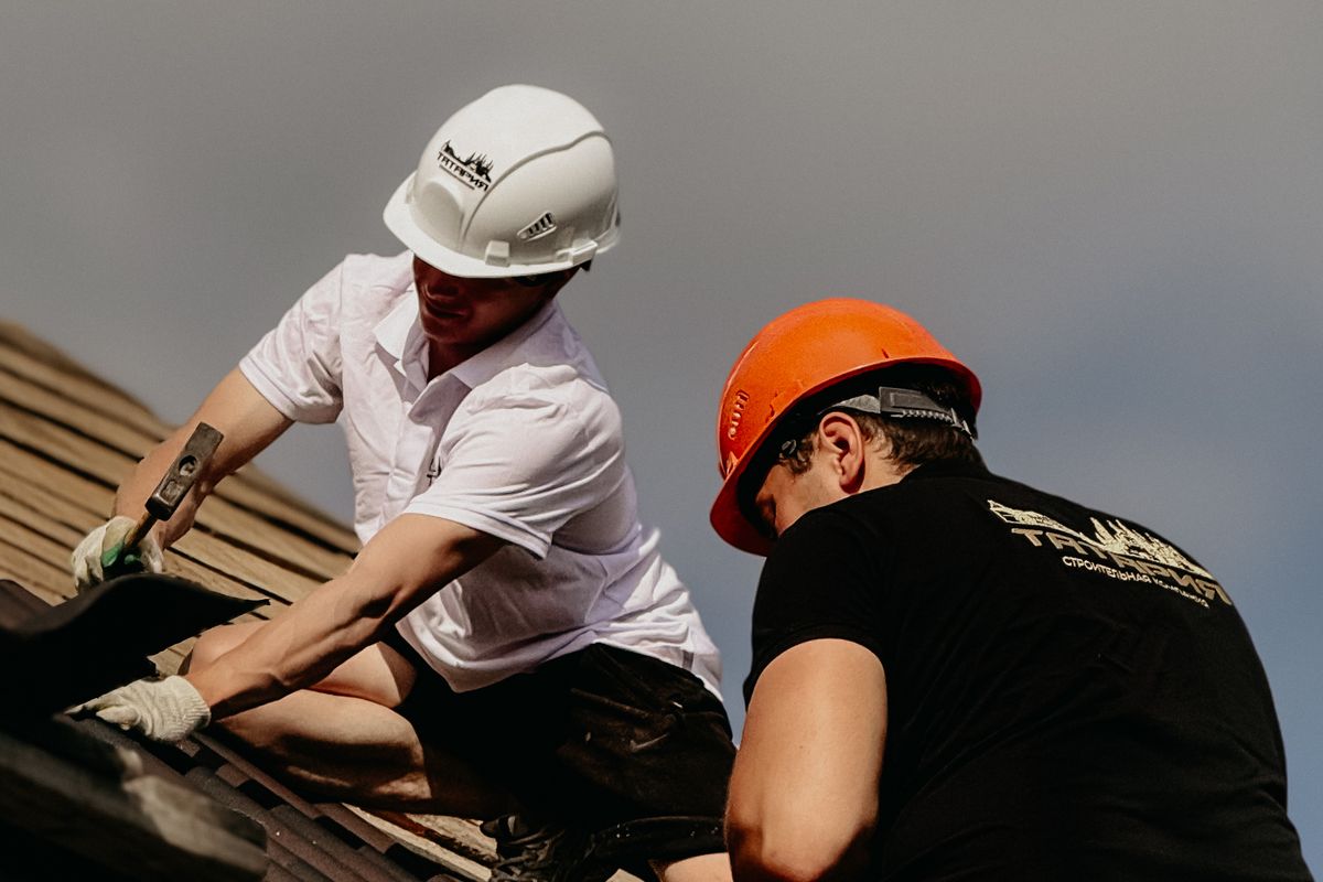 Roofing crew working together on a residential roof